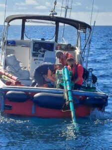 Three field team members on a boat