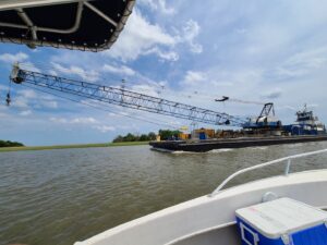 Picture taken from ANAMAR's vessel of a barge and crane in South Carolina Intercoastal Waterway.