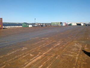 Industrial area with three cargo containers marked 